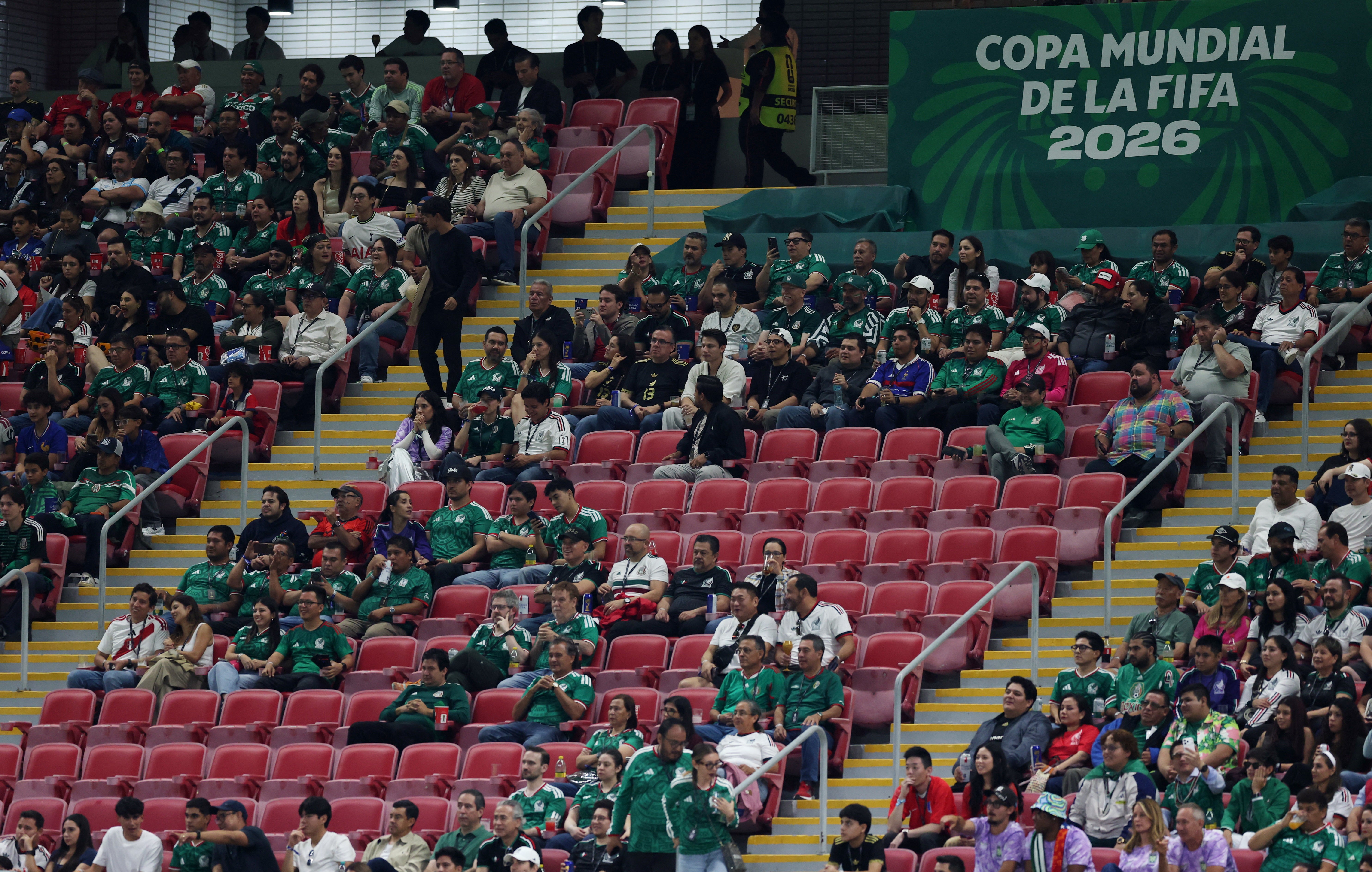 Empty seats are seen in the stands during the match