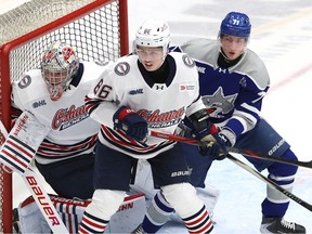 Adam Nemec, right, of the Sudbury Wolves battles for position in front of the Oshawa Generals' net