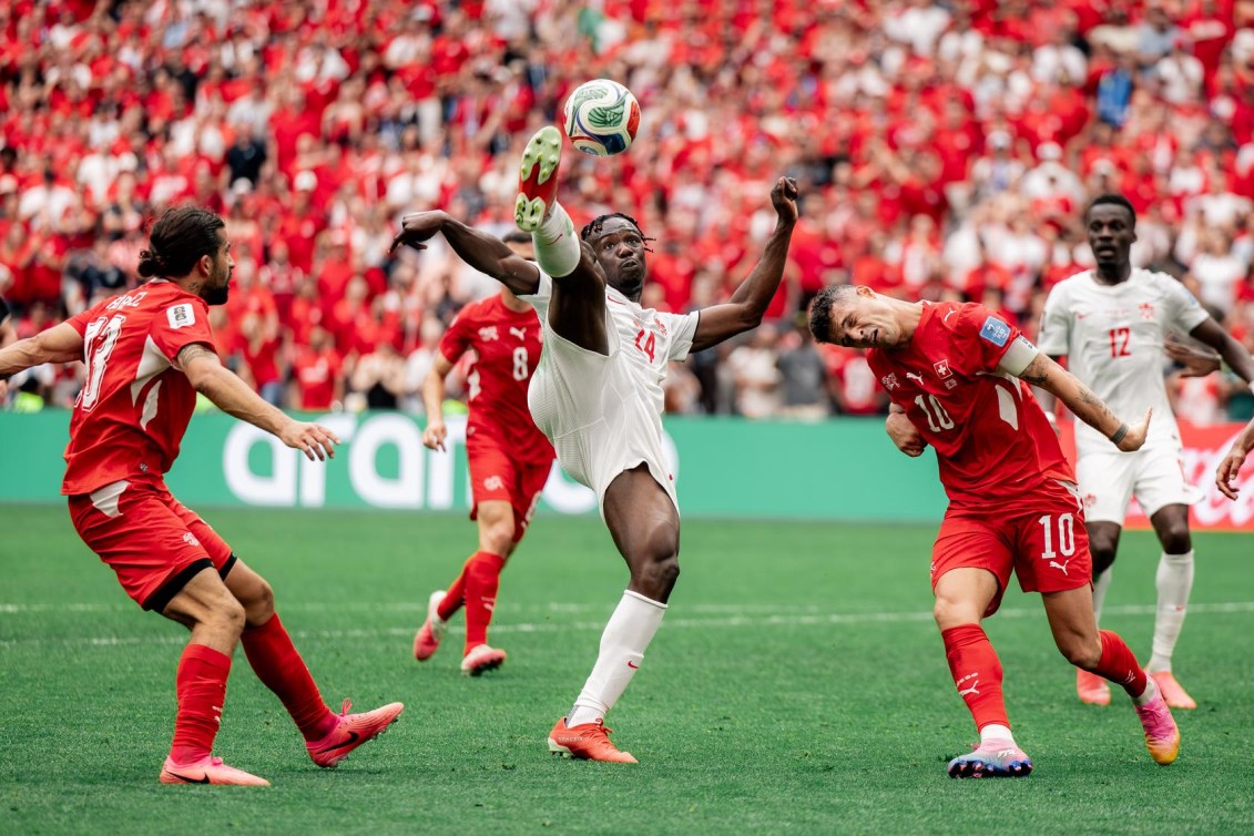 Canada's Promise David controls a high ball against Switzerland.