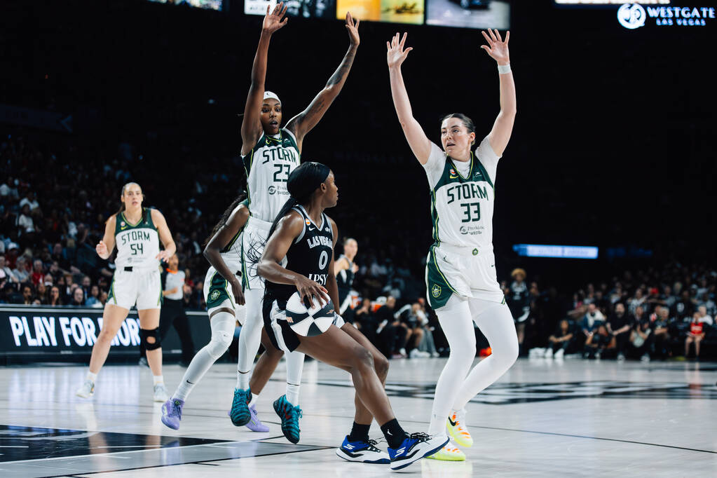 Aces guard Jackie Young (0) is met by Seattle Storm defense in a WNBA basketball game at Michel ...