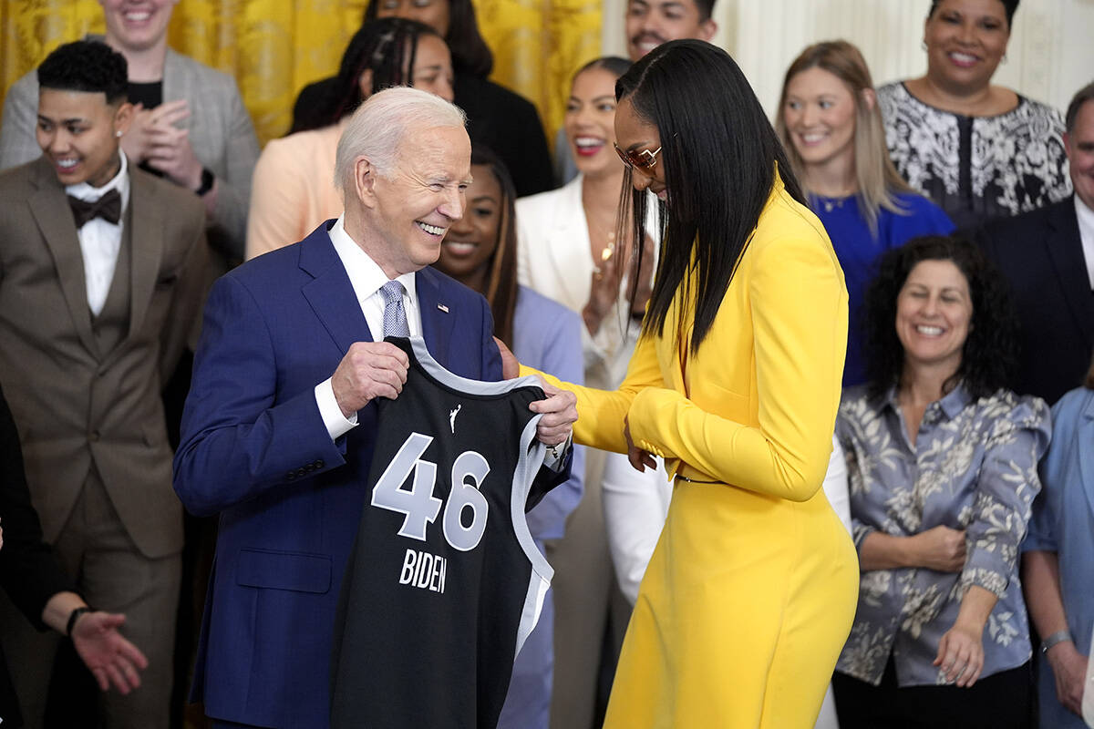 A'ja Wilson, of the WNBA's Las Vegas Aces, right, presents a jersey to President Joe ...