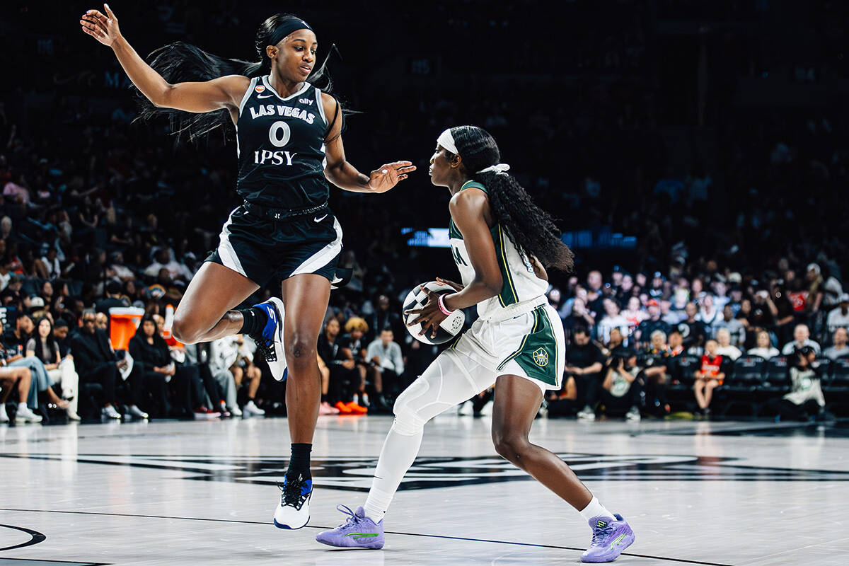 Aces guard Jackie Young (0) plays defense against Seattle Storm guard Flau'jae Johnson (4) ...
