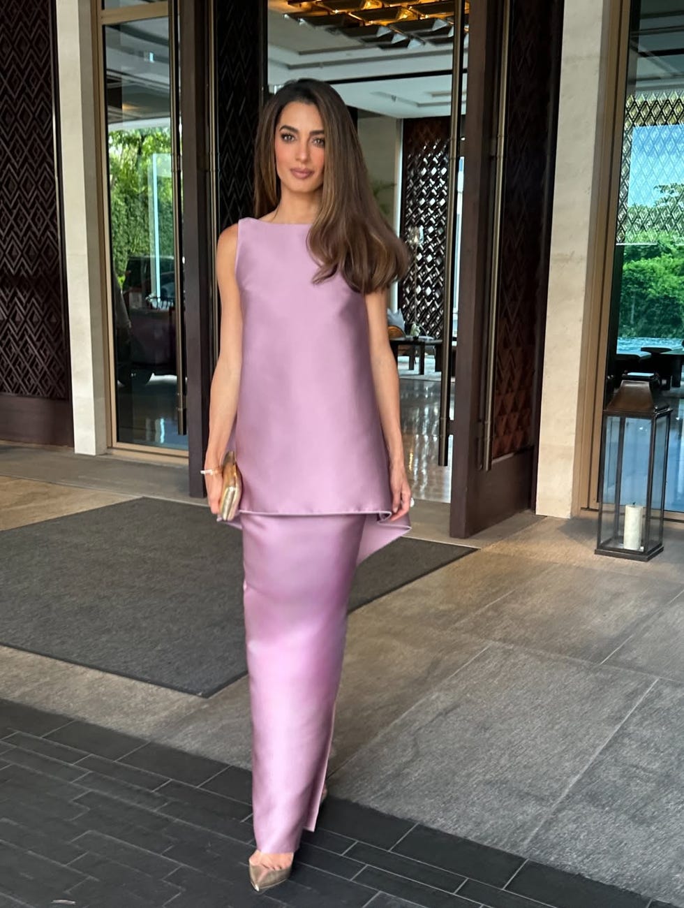 Person in elegant lavender dress standing in an open doorway. Person in elegant lavender dress standing in an open doorway.
