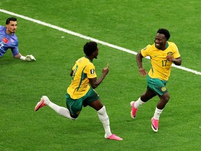 Nestory Irankunda #17 of Australia celebrates scoring his team's first goal with teammate Mohamed Toure #9 during the FIFA