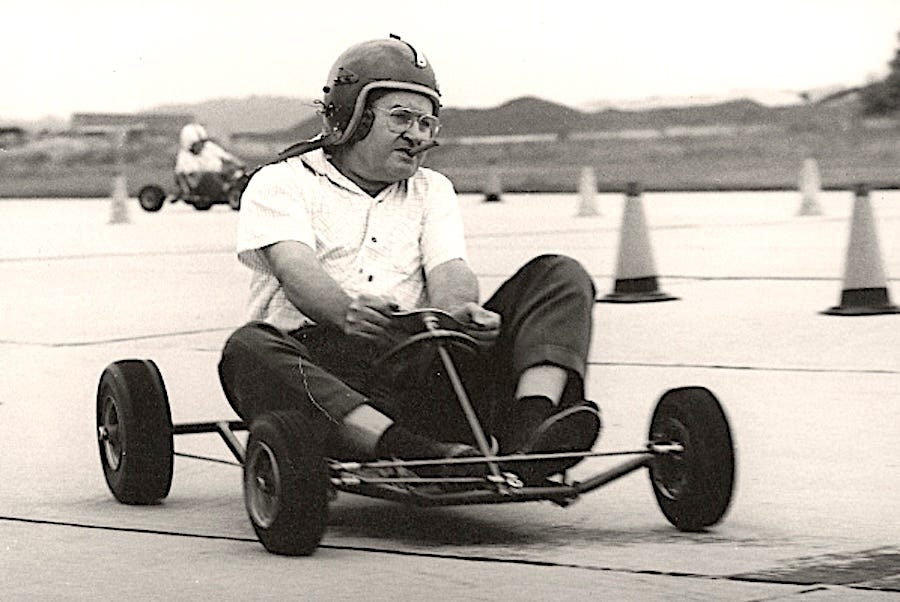 person driving a gokart on a track