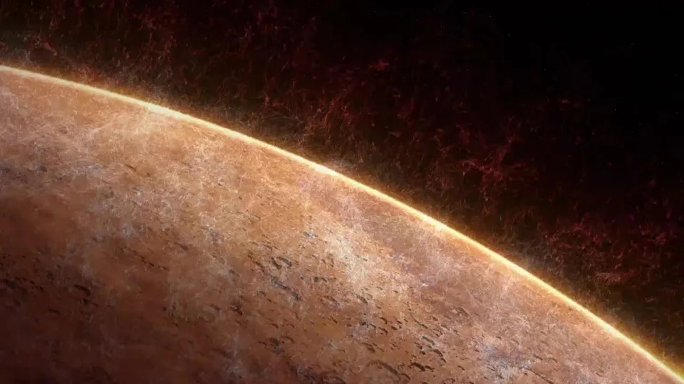 A close up of Mars' red surface, showing water rising from it