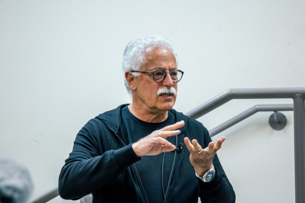 A close-up image of Daniel Gruner gesturing with his hands.