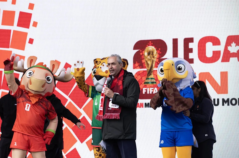 Chief Operating Officer Canada for FIFA Peter Montopoli is joins by mascots from left to right, Maple, Zayu and Clutch during remarks to soccer fans who gathered on the grounds of the legislature to take part in the FIFA World Cup 2026 countdown celebration event in Victoria, B.C., on Tuesday, March 31, 2026. THE CANADIAN PRESS/Chad Hipolito