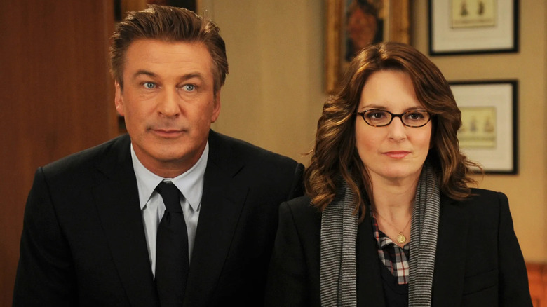 Jack and Liz standing side by side and looking on