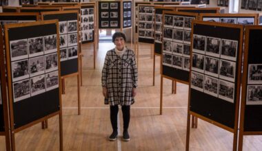Harrop-Procter photographer Ursula Heller stands among the 498 photographs that made up her exhibit entitled Our Side. (Bill Metcalfe/Nelson Star)