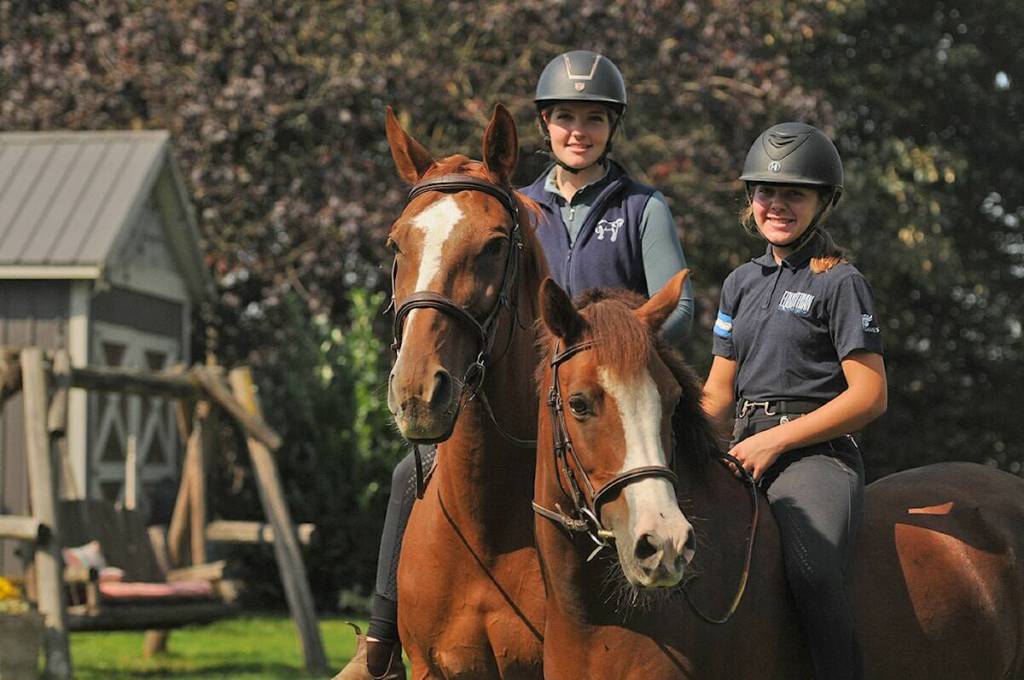 Equestrian sisters 18-year-old Shelby Kramp, left, and 13-year-old Alexis are pictured at their Chilliwack farm in 2025. (Black Press file photo)