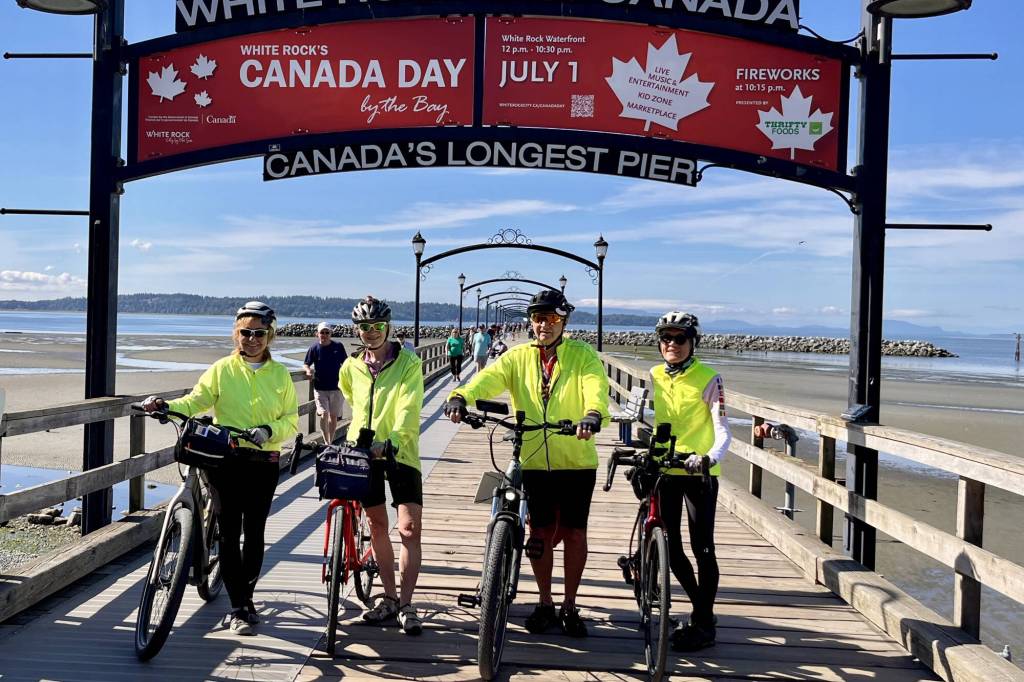 Donna McLean, left, Fran Wolfe, and Joan Donohue flank 83-year-old cyclist Robert Fletcher on the iconic White Rock pier Friday morning (June 12) before he started on an 8,600 cross-Canada journey over the summer. He&rsquo; turns 84 in August, when he&rsquo;ll be in Quebec, according to his travel route. (Tricia Leslie/Peace Arch News)