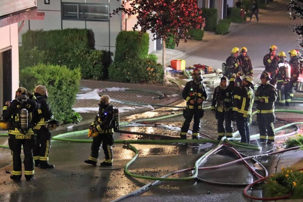 Firefighters in Surrey were busy fighting a townhouse fire in South Newton Sunday night (June 14). (Riya Toor/Contributed to Peace Arch News)