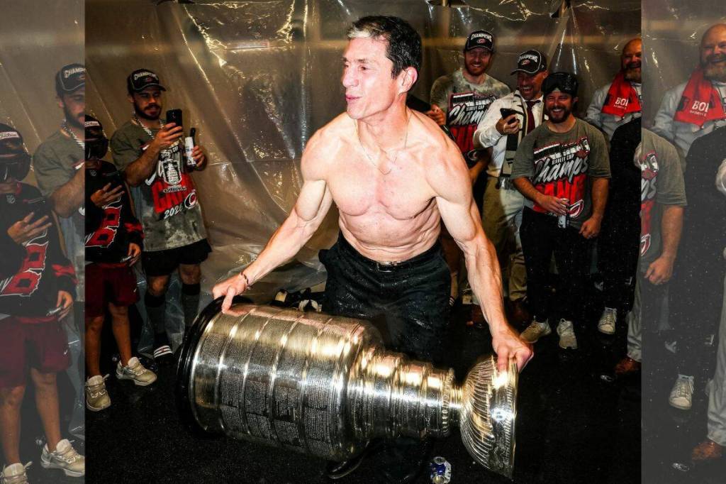 Carolina Hurricanes head coach Rod Brind&rsquo;Amour hoists the Stanley Cup in the Hurricanes dressing room following the conclusion of Game 6 in Vegas. (Photo courtesy of Carolina Hurricanes/Facebook)