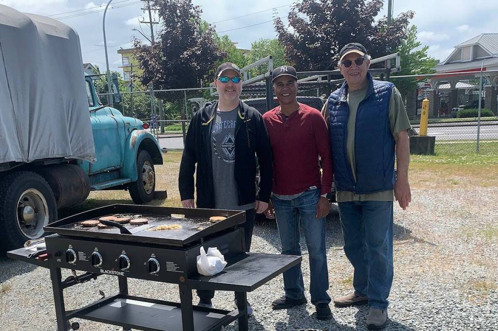 Directors from the Cloverdale Community Association (CCA) hold a BBQ at the B.C. Vintage Truck Museum in 2025&mdash;one of their many outreach events. From left: Andrew Brlic (treasurer), Ram Sabharwal (president), and Ken Bauder (VP). Sabharwal and the CCA have released the results of a recent survey which sought to get a pulse on what residents of East Surrey are thinking on a number of public issues. (Photo: Malin Jordan/Cloverdale Reporter)