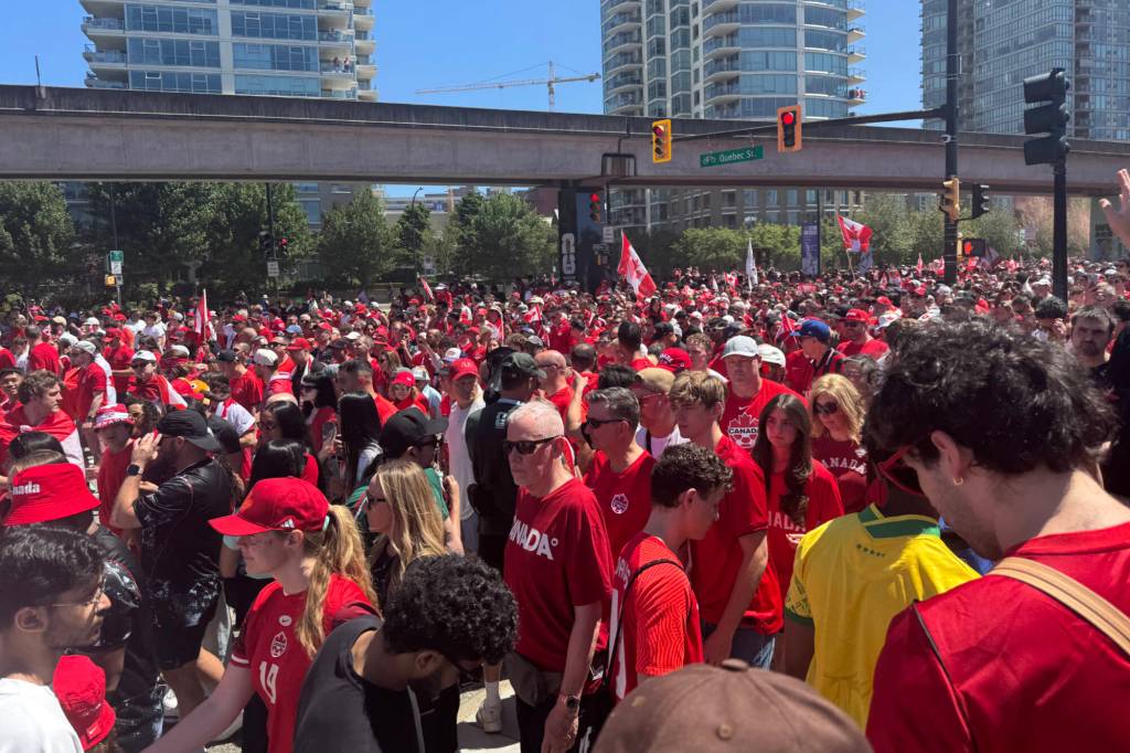 Thousands of Canadian fans in red are marching through downtown as Canada prepares to face Qatar in its first World Cup match in Vancouver. (Lauren Collins/Black Press Media)