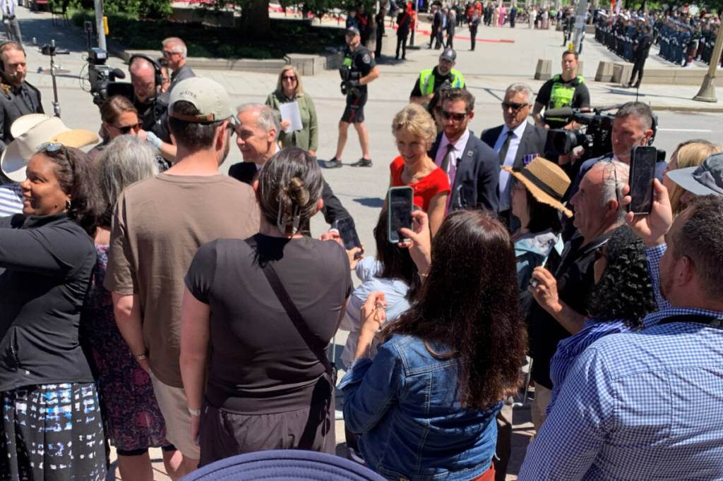 A Vernon father and his daughter happened to be outside as the swearing-in of Canada&rsquo;s new Governor-General wrapped up in Ottawa Monday, June 8, when Prime Minister Mark Carney (centre) and wife Diana (red) joined the crowd and chatted with the Okanagan duo. (Contributed)