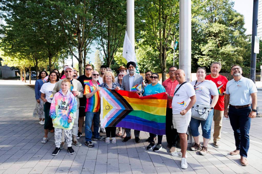 Members from various local 2SLGBTQIA+ pose for a photo with Surrey mayor Brenda Locke and Senator Baltej Dhillon before raising the progress Pride flag at City Hall on Friday, June 19, 2026. (Anna Burns/ Surrey Now-Leader)