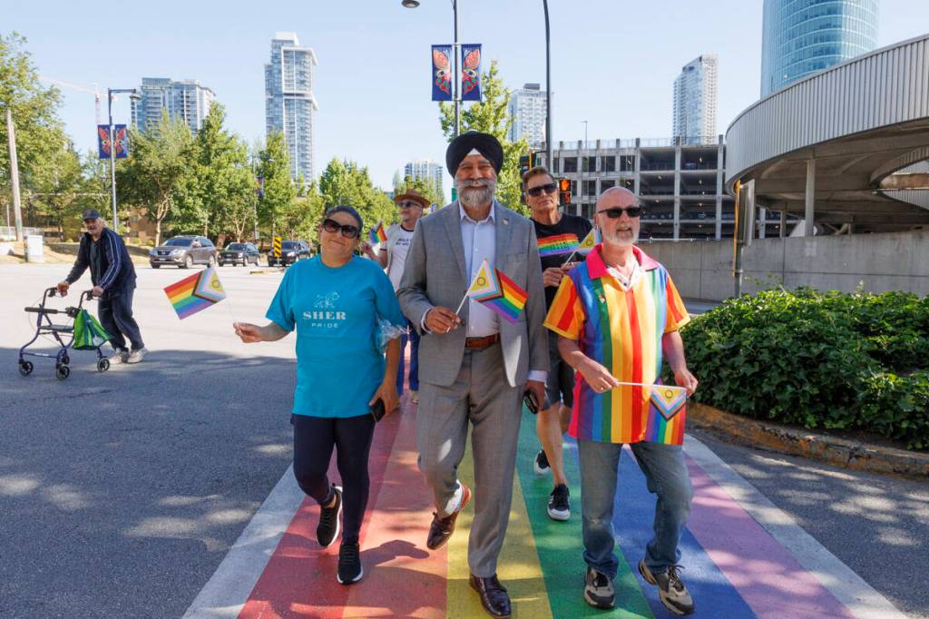 Members from various local 2SLGBTQIA+ walk across the Rainbow crosswalk in Surrey on Friday, June 19, 2026. (Anna Burns/ Surrey Now-Leader)