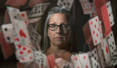 Chilliwack author Phillippa Mann recently released her memoir &lsquo;House of Cards&rsquo;. She is pictured here in a reflection of a poster for her book at her home on June 4, 2026. (Jenna Hauck/ Chilliwack Progress)