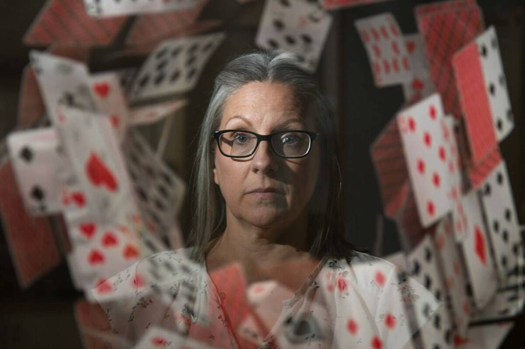 Chilliwack author Phillippa Mann recently released her memoir &lsquo;House of Cards&rsquo;. She is pictured here in a reflection of a poster for her book at her home on June 4, 2026. (Jenna Hauck/ Chilliwack Progress)