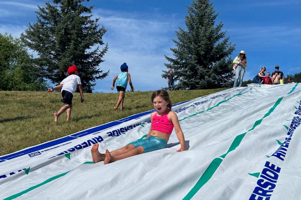 Children enjoyed the slip and slide at the City of Williams Lake&rsquo;s Canada Day party last year. (File photo)