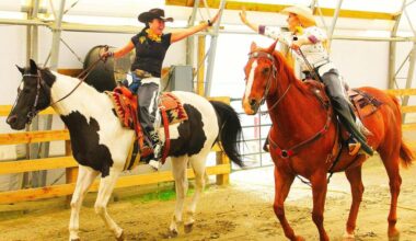Sheila Hicks, president of Valley West Stampede (seen here on Par), and Abbey Harty, Miss Rodeo Canada 2026 (seen here on Red), high five during a promotional shoot for Valley West Stampede. (Photo: Malin Jordan/Cloverdale Reporter)
