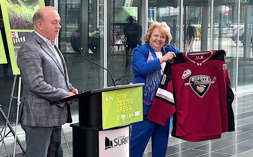 Surrey Mayor Brenda Locke holds a Vancouver Giants hockey jersey while Ron Toigo, team president and majority owner, speaks during a news conference at Surrey City Hall to announce the city&rsquo;s new 10,000-seat arena plans, on Tuesday, June 20, 2026. (Tom Zillich/Surrey Now-Leader)