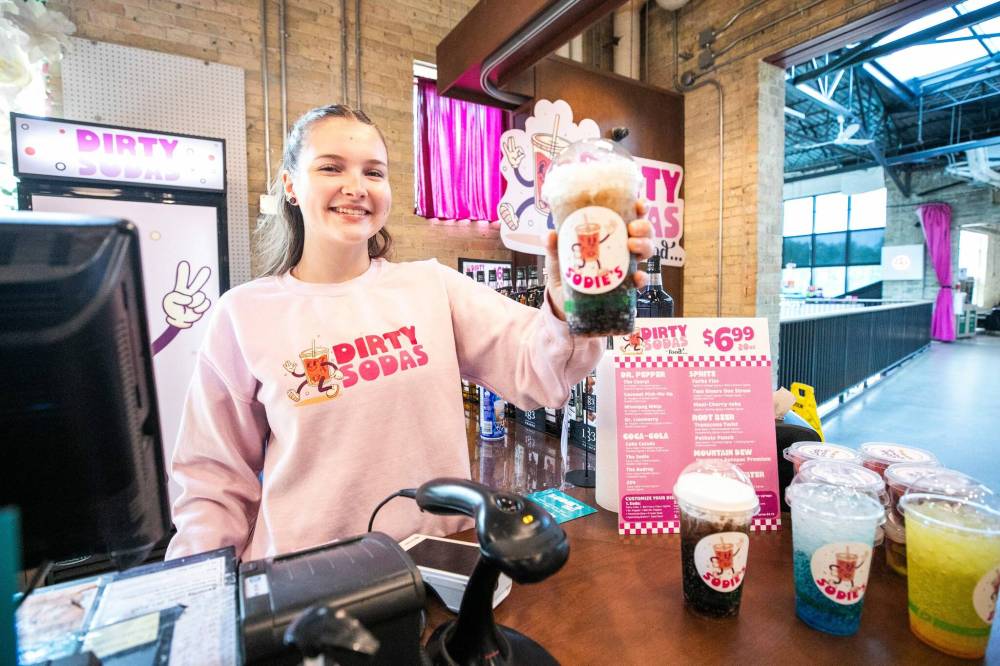 MIKAELA MACKENZIE / FREE PRESS
Kalila Sullivan serves up the Coke Colada at Sodie’s Dirty Sodas, located at the Forks Trading Company.