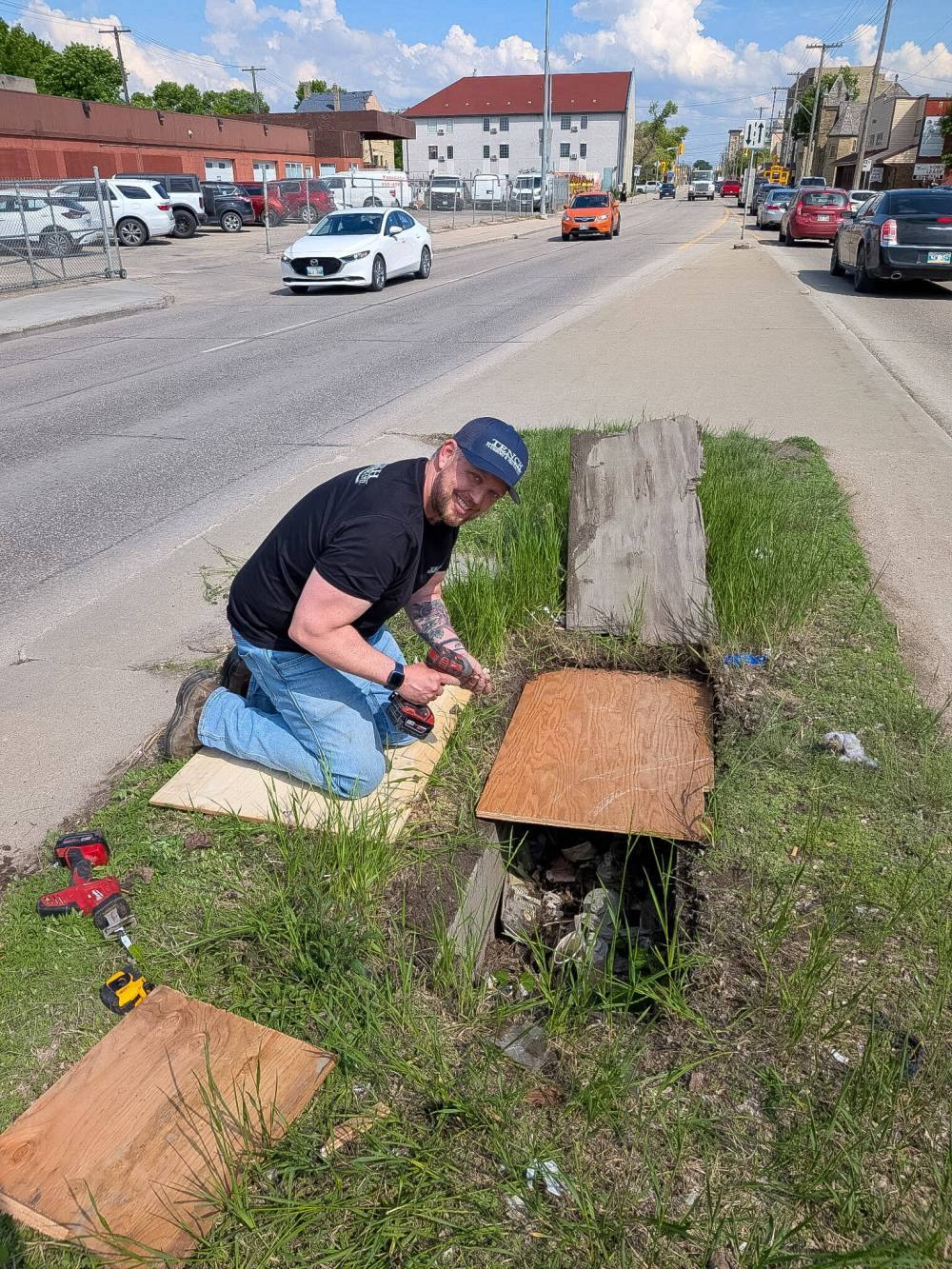 SUPPLIED
Robert Firman, operations manager with a nearby plumbing and heating company, provides a temporary fix to cover a hole on Logan Avenue near Patrick Street Thursday.