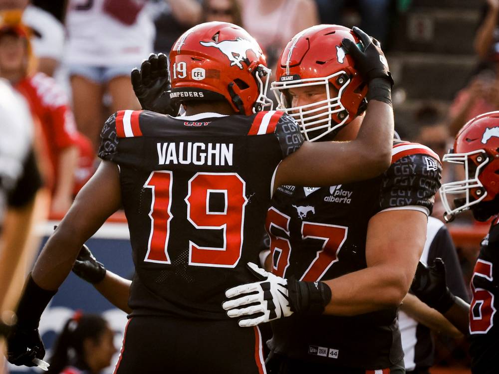 Calgary Stampeders quarterback Quincy Vaughn, left, celebrates a touchdown with teammate Zack Williams in 2025. THE CANADIAN PRESS FILES/Jeff McIntosh