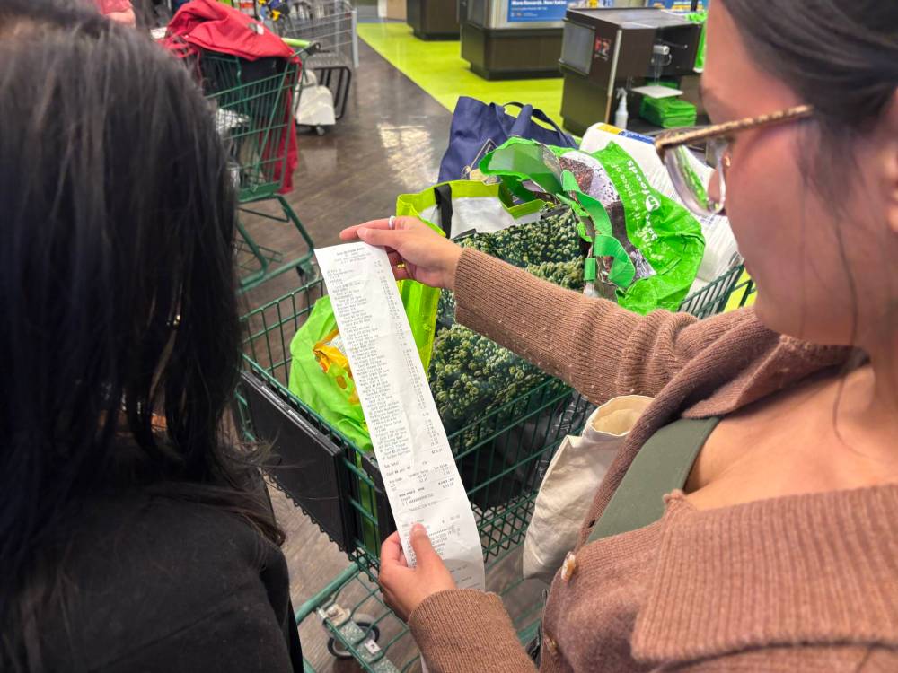 CONRAD SWEATMAN / FREE PRESS
Samia Leake searches her grocery bill to find the PST savings: $4.44 on this trip.