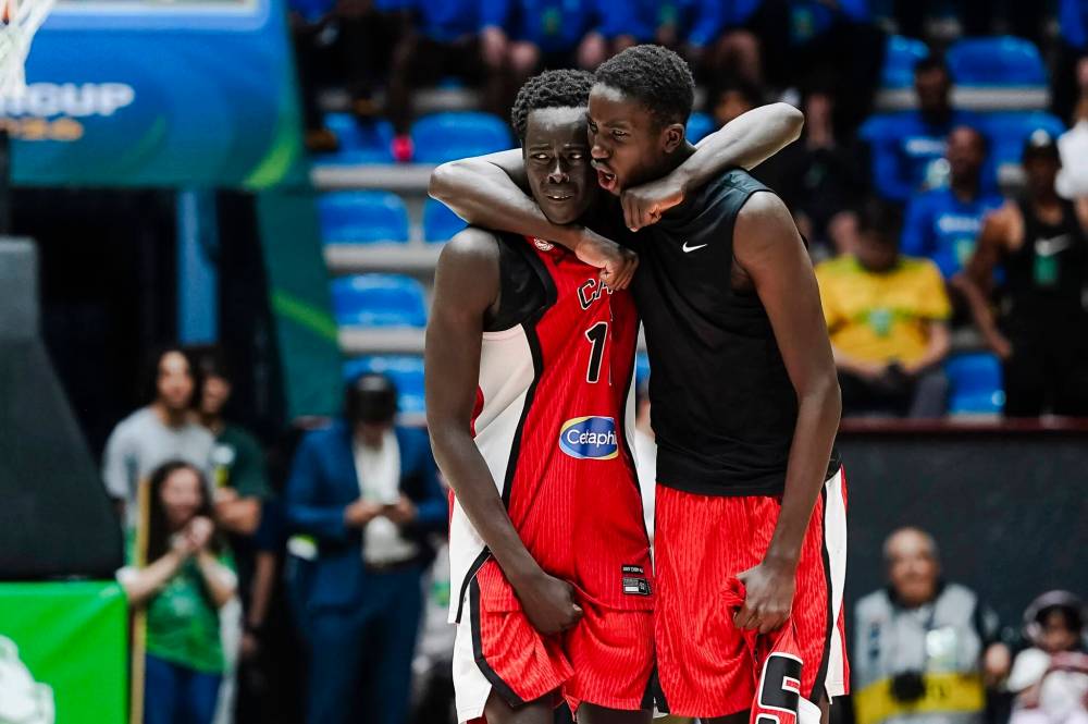 FIBA.BASKETBALL PHOTO
Winnipeg’s Settimo Yugu (right) celebrates with a teammate.