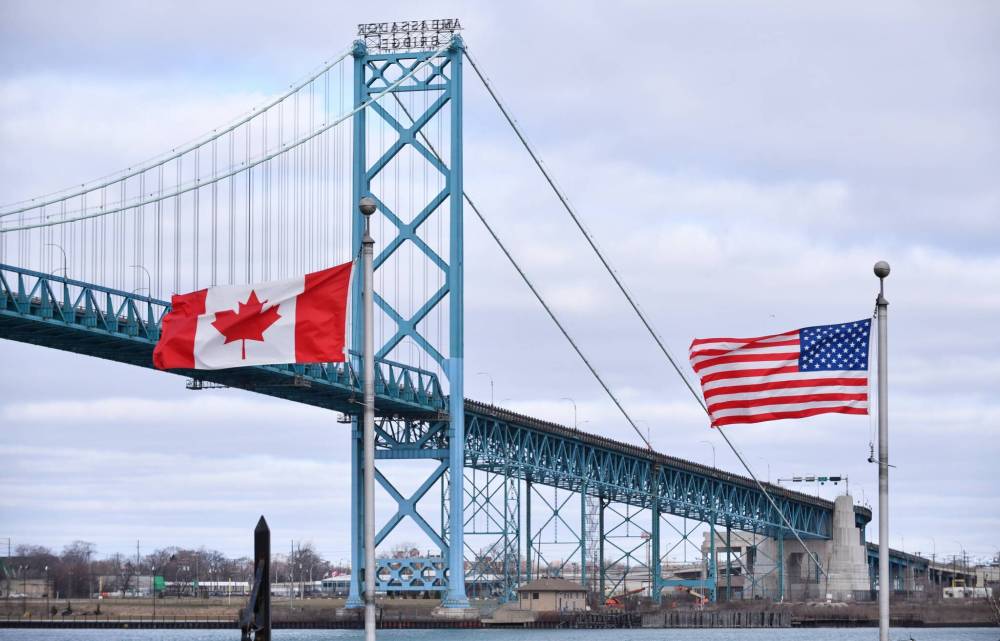 ROB GURDEBEKE / THE CANADIAN PRESS FILES
Canadian and American flags fly near the Ambassador Bridge at the Canada/USA border crossing in Windsor, Ont. Trump has obstructed the official opening of the bridge.
