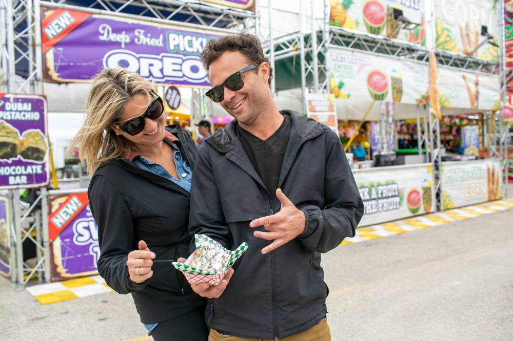 BROOK JONES/FREE PRESS
Corn Dogs & Deep Fried Pickle Oreos owners Sam Swift (left) and her husband, Harrison, show off their deep-fried pickle Oreos Friday at the Ex.