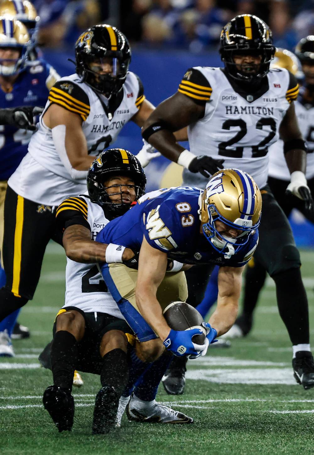 JOHN WOODS / THE CANADIAN PRESS
Winnipeg Blue Bombers receiver Tommy Nield fights for yards against the Hamilton Tiger-Cats defence. The receiver had his first career 100-yard game on Thursday night.