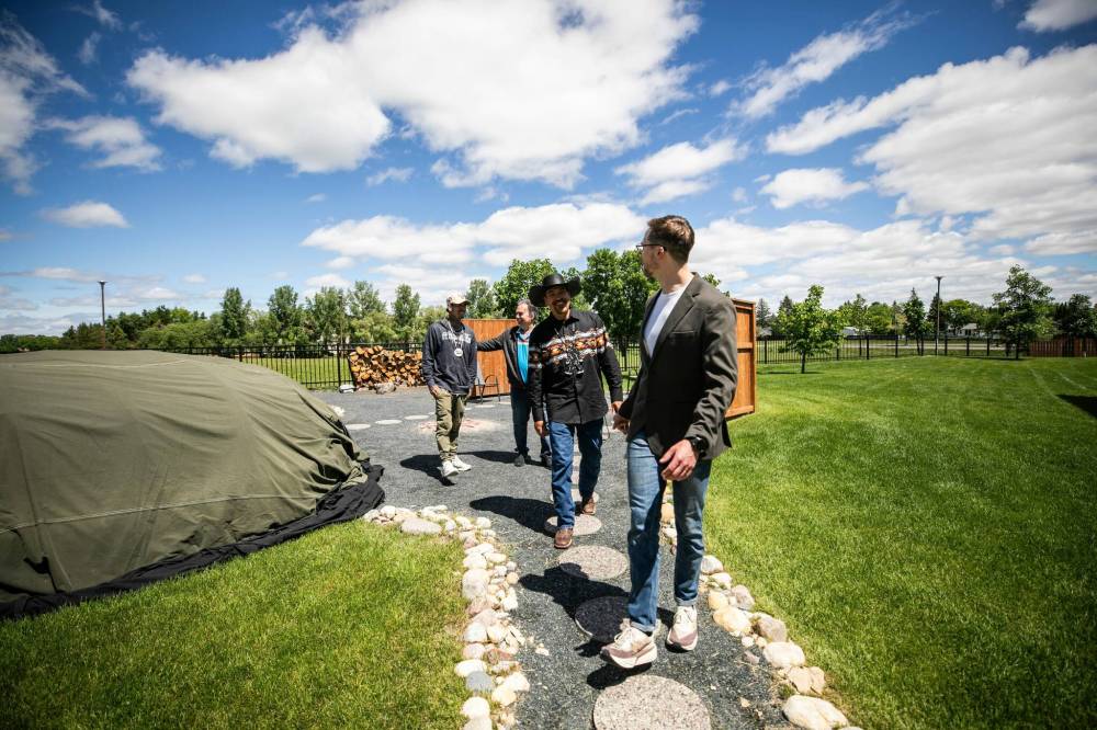MIKAELA MACKENZIE / FREE PRESS
Terrence Morin (from left), knowledge carriers Louis Sorin and Kyle McClintock, and staff member Kyle Goertzen by the centre’s sweat lodge, located at the rear of the property.
