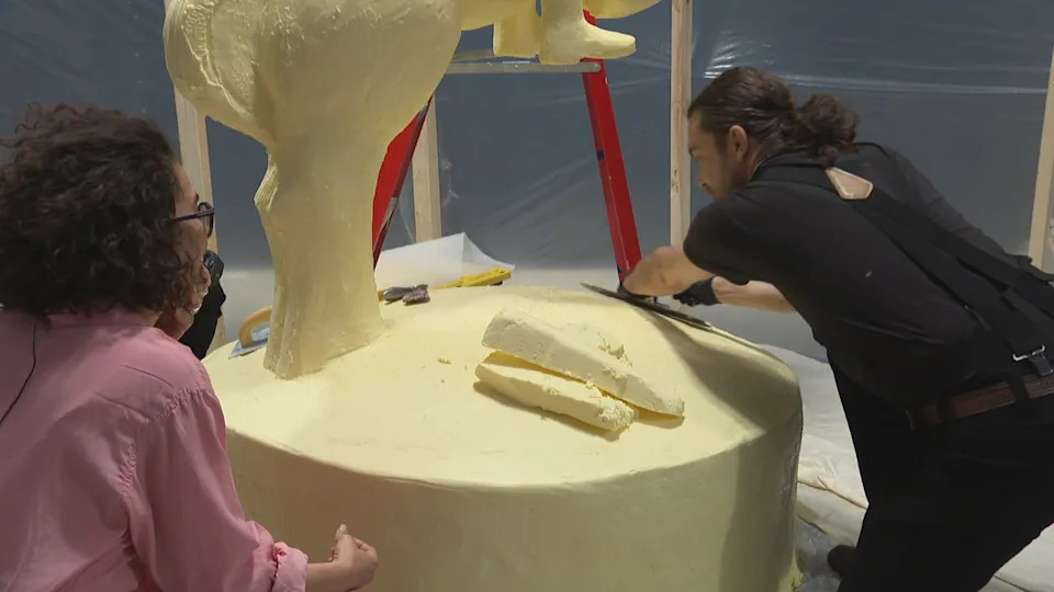 Ghazaleh Avarzamani, left, and sculptor Ryan Kurylo work on the butter sculpture.