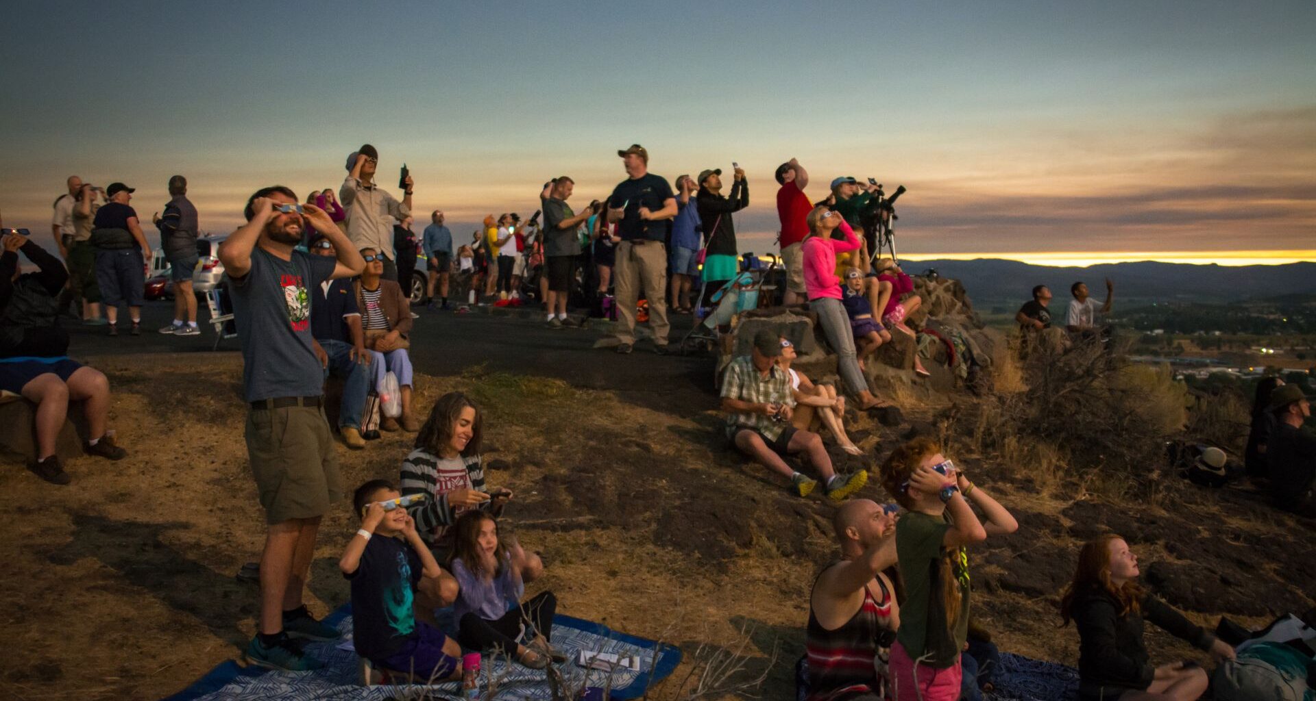 people gather to watch a total solar eclipse