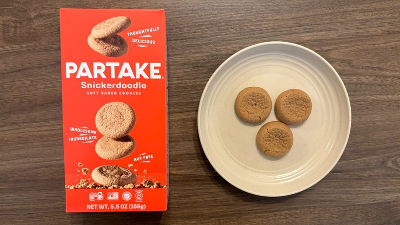 Partake Soft Baked Snickerdoodle Cookies box and gluten-free cookies on brown plate