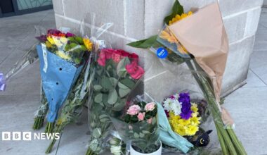 Flowers left at the entrance to a flat.