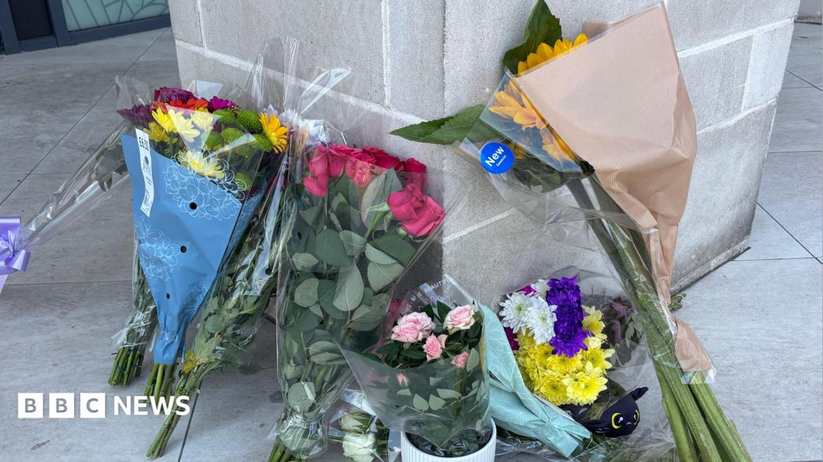 Flowers left at the entrance to a flat.