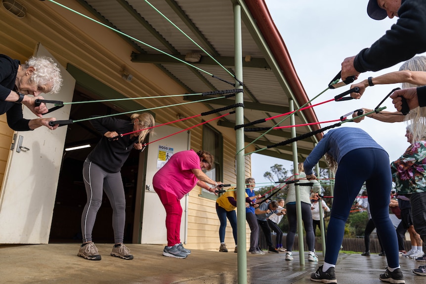 People working out in a community hall.