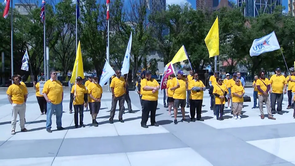 Amalgamated Transit Union members rallied around bus driver Amarjit Grewal (centre, wearing long grey sleeves) on June 19, 2026, in Calgary.