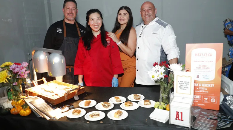 OCTOBER 19: (R) Chef Max Calicchio and his team pose for photos during Steak & Whiskey presented by A.1. Sauce hosted by Robert Irvine during Food Network New York City Wine & Food Festival presented by Invesco QQQ at Hall Des Lumieres on October 19, 2024 in New York City. (Photo by Astrid Stawiarz/Getty Images for NYCWFF)