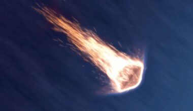 a space capsule descends the atmosphere surrounded by hot flaming embers
