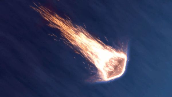 a space capsule descends the atmosphere surrounded by hot flaming embers