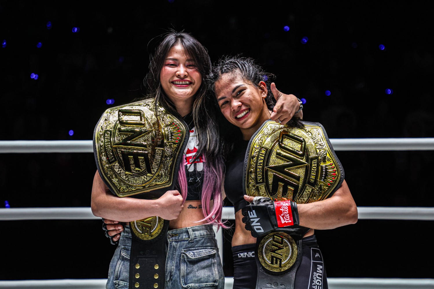 Stamp Fairtex and Denice Zamboanga pose together with their ONE Championship belts after Zamboanga’s interim title win at ONE Fight Night 27.