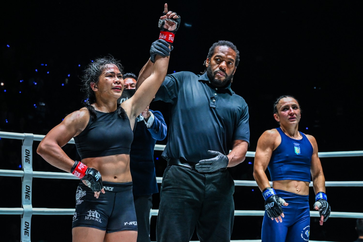 Denice Zamboanga has her hand raised after beating Alyona Rassohyna to win the ONE interim atomweight MMA world title at ONE Fight Night 27.