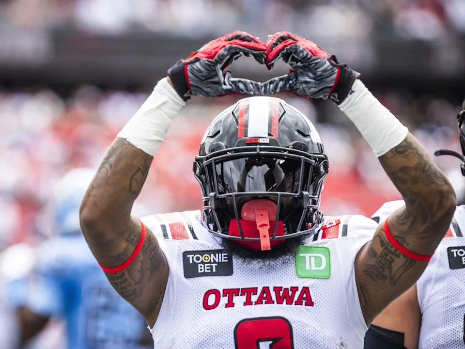 Justin Hardy makes a heart gesture after the Redblacks scored a touchdown against the Argonauts during the first half.